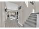 Bright hallway with staircase, grey flooring, and access to the open-concept living area at 625 Honesty Ct, Henderson, NV 89011