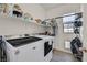 Well-organized laundry room with modern washer and dryer, open shelving, and ample storage space at 625 Honesty Ct, Henderson, NV 89011