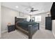 Serene main bedroom featuring a ceiling fan, a king-sized bed, and a large dark wood dresser at 625 Honesty Ct, Henderson, NV 89011