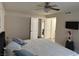 Cozy bedroom with ceiling fan, TV, orchid, and ensuite bathroom access at 669 Oakmont Ave # 3709, Las Vegas, NV 89109