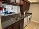 Open kitchen layout with dark cabinets, granite counters, and pass through at 669 Oakmont Ave # 3709, Las Vegas, NV 89109