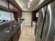 Kitchen featuring dark granite counters, stainless appliances and open counter at 669 Oakmont Ave # 3709, Las Vegas, NV 89109