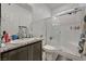 Bright bathroom featuring a granite countertop vanity and a glass-enclosed shower at 6747 Marjoram St, Las Vegas, NV 89166