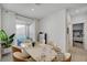 Cozy dining area with a stone table, modern chairs, and access to the outdoor patio at 6747 Marjoram St, Las Vegas, NV 89166