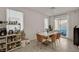 Bright dining area with modern furniture and sliding doors leading to the outdoor patio at 6747 Marjoram St, Las Vegas, NV 89166