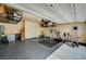 A spacious garage with high ceilings, storage racks, a home gym area, and painted walls at 6747 Marjoram St, Las Vegas, NV 89166