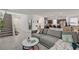 Open living area with tile floors, stairs, and a comfortable gray sofa at 6747 Marjoram St, Las Vegas, NV 89166