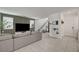 Bright living room features a stylish TV wall, modern decor, and easy access to the staircase at 6747 Marjoram St, Las Vegas, NV 89166