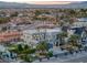 Expansive aerial view of a modern home with lush landscaping, pool, and city views at 675 Benedict Dr, Las Vegas, NV 89110