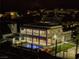 Experience a breathtaking night aerial view of an elegant home with a pool and outdoor recreation areas at 675 Benedict Dr, Las Vegas, NV 89110