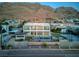 Expansive aerial view of a luxury property, highlighting the pool, basketball court, and mountain backdrop at 675 Benedict Dr, Las Vegas, NV 89110