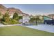 Inviting backyard featuring lush landscaping, a basketball court, and a swing set for outdoor enjoyment at 675 Benedict Dr, Las Vegas, NV 89110