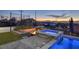 Relaxing backyard area featuring a hot tub, fire pit, and sport court at 675 Benedict Dr, Las Vegas, NV 89110