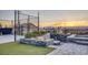 Enjoy a twilight view of the basketball court, firepit and the pool beyond at 675 Benedict Dr, Las Vegas, NV 89110