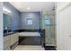 Contemporary bathroom with blue walls, soaking tub, and glass-enclosed shower at 675 Benedict Dr, Las Vegas, NV 89110