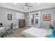 Comfortable bedroom with a ceiling fan, private balcony, and a dedicated desk area at 675 Benedict Dr, Las Vegas, NV 89110