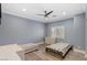 Spacious bedroom with neutral paint, ceiling fan, and two twin beds with wood frames at 675 Benedict Dr, Las Vegas, NV 89110