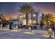 Beautiful modern home with desert landscaping, a gated entrance, and stone accents at twilight at 675 Benedict Dr, Las Vegas, NV 89110