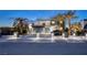 Charming modern home featuring palm trees, sleek lines, and a private gated driveway at 675 Benedict Dr, Las Vegas, NV 89110