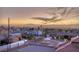 Sunset aerial view of the city and mountains behind a neighborhood of homes at 675 Benedict Dr, Las Vegas, NV 89110