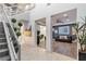 Bright foyer with soaring ceilings, glass railing staircase, and views into formal dining and living room at 675 Benedict Dr, Las Vegas, NV 89110