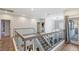 Upstairs hallway showcasing glass railings and wood floors at 675 Benedict Dr, Las Vegas, NV 89110