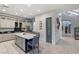 Bright kitchen featuring an island with a white countertop and barstool seating and a walk-in pantry at 675 Benedict Dr, Las Vegas, NV 89110