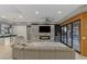 Open living room features stacked stone accent wall with fireplace, wood-look accents and doors to outdoors at 675 Benedict Dr, Las Vegas, NV 89110