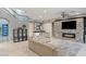 Bright living room showcases a fireplace, stairway access, and natural light from surrounding windows at 675 Benedict Dr, Las Vegas, NV 89110