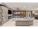 Expansive living room offers an entertainment center with fireplace, tile floors, and doors to outdoors at 675 Benedict Dr, Las Vegas, NV 89110