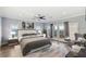 Main bedroom with wood floors and a sitting area boasts natural light from windows and a balcony at 675 Benedict Dr, Las Vegas, NV 89110