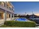 Inviting backyard features a sparkling in-ground pool and a modern two-story home at 675 Benedict Dr, Las Vegas, NV 89110
