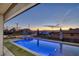 Beautiful blue in-ground pool and hot tub, complemented by artificial turf at 675 Benedict Dr, Las Vegas, NV 89110