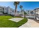 Well-maintained community grounds and pool area featuring mature palm trees and lush green grass at 6800 E Lake Mead Blvd # 1034, Las Vegas, NV 89156