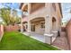 This home boasts a charming backyard with synthetic grass, patio, and multi-story design at 6856 Pipil St, Las Vegas, NV 89166