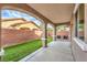 The covered patio in the backyard offers both shade and style with its arched columns and brick features at 6856 Pipil St, Las Vegas, NV 89166