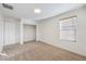 This cozy bedroom features plush carpeting, a window, and a closet for easy storage at 6856 Pipil St, Las Vegas, NV 89166