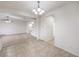 Open-concept dining area with tile flooring, chandelier, and easy access to the carpeted living room and stairs at 6856 Pipil St, Las Vegas, NV 89166