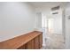 Second floor hallway features a long wood cabinet along the wall and white stairway at 6856 Pipil St, Las Vegas, NV 89166