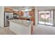 Kitchen showcasing granite countertops, stainless steel appliances, and easy access to the backyard through sliding doors at 6856 Pipil St, Las Vegas, NV 89166