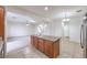 Granite kitchen island with wood cabinets overlooking the open concept living area at 6856 Pipil St, Las Vegas, NV 89166