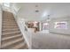 Open-concept living area with carpeted stairs, kitchen, and backyard access at 6856 Pipil St, Las Vegas, NV 89166