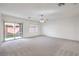 Bright and airy living room with sliding glass doors to the backyard and a ceiling fan at 6856 Pipil St, Las Vegas, NV 89166