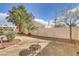 The backyard shows a charming patio with beautiful landscaping and a decorative fire pit at 7973 Macklin St, Las Vegas, NV 89129