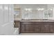 Modern bathroom features double vanity, granite counters, and wood-look cabinets at 7973 Macklin St, Las Vegas, NV 89129