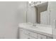 Bathroom featuring a white sink, tiled countertop, and classic fixtures at 7973 Macklin St, Las Vegas, NV 89129