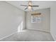 Carpeted bedroom features ceiling fan and natural light from window at 7973 Macklin St, Las Vegas, NV 89129