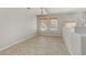Dining area features tile flooring, a chandelier, and neutral wall paint at 7973 Macklin St, Las Vegas, NV 89129