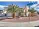 Charming stucco home features desert landscaping, a multi-car garage, and manicured palm trees at 7973 Macklin St, Las Vegas, NV 89129