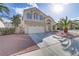Inviting two-story home boasts desert landscaping, a two-car garage, and a stucco exterior at 7973 Macklin St, Las Vegas, NV 89129